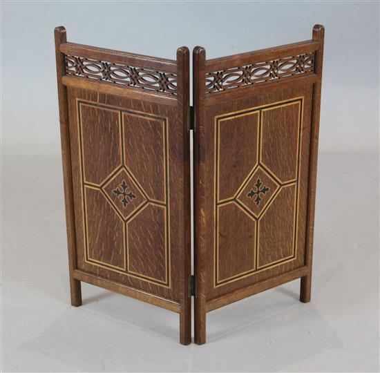 A Victorian Gothic revival inlaid oak small two fold fire screen, H.2ft 1in.